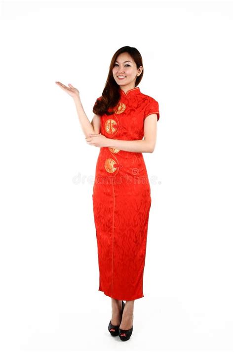 Chinese Woman In Traditional Red Cheongsam Presenting Stock Photo