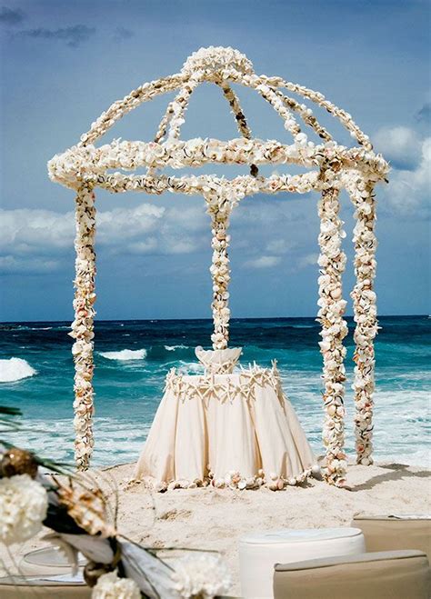 talk about seaside glamour this open aired arbor is made entirely of seashells wedding beach