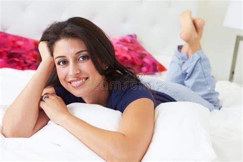 Woman Relaxing In Bed Wearing Pajamas Stock Image Image Of Relaxing Bedding