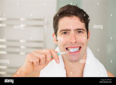 Close Up Portrait Of Man Brushing Teeth In Bathroom Stock Photo Alamy