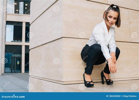 A Cheeky Business Lady Squatting Extravagant Squatgirl In A Business
