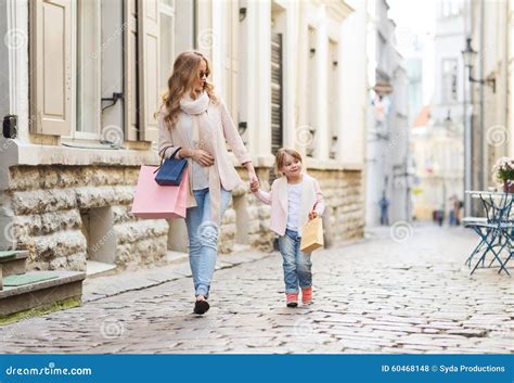 Happy Mother And Child With Shopping Bags In City Stock Photo Image