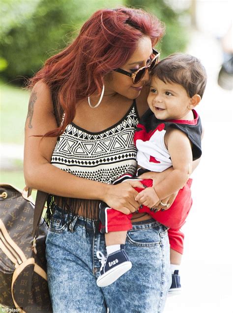 snooki s one happy momma reality star can t stop smiling as she takes little lorenzo out for a