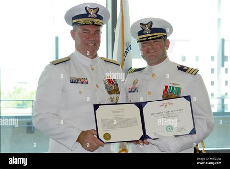Coast Guard Vice Adm Karl L Schultz And Cmdr Justin M Carter Hold A