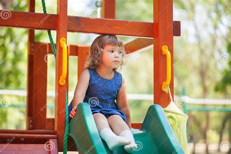 Little Kid On Playground Children`s Slide Stock Photo Image Of