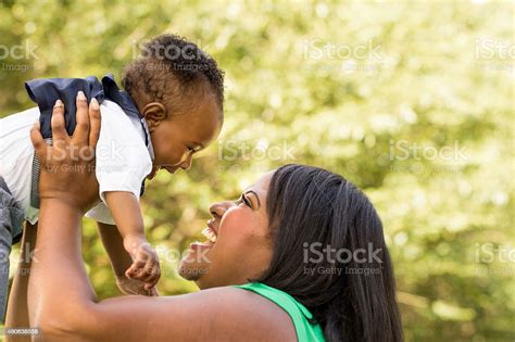 African American Mother Holding Her Son Stock Photo Download Image