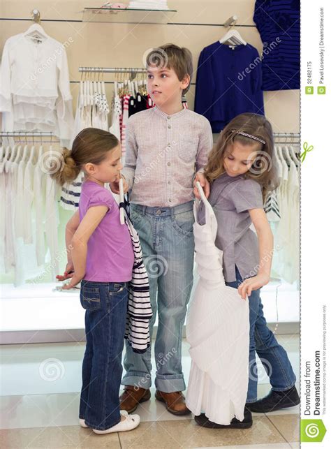The Boy Helps Girls To Choose Clothes In Shop Stock Image Image Of