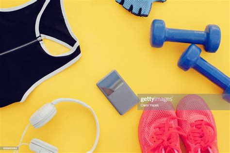 Flat Lay Shot Of Woman Sport Equipment Shoes Water Earphone And Phone