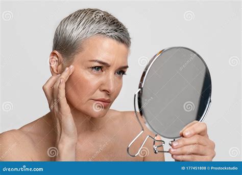 Skin Aging Mature Woman Looking In The Mirror Checking Her Wrinkles