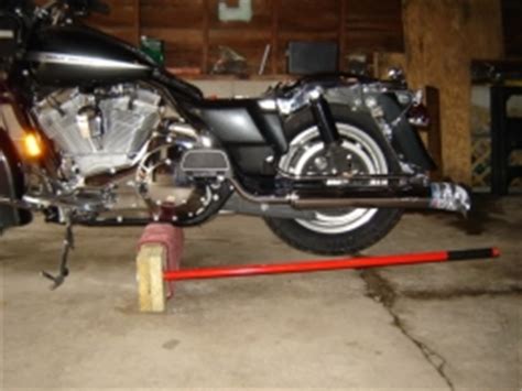 Homemade motorcycle lift constructed from 3/4 plywood, gi pipe, and wooden planks. Homemade Motorcycle Jack - HomemadeTools.net