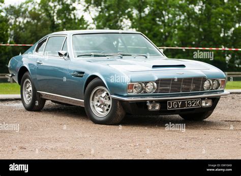 A blue classic car (Aston Martin) from the early 1970s shown Stock
