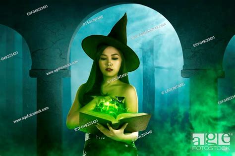 Asian Witch Woman Holding The Book In Empty Room Horror Situation With Fog Background Stock