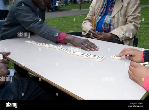 Men Playing Dominoes In The Park Stock Photo Alamy