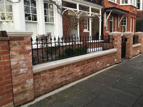 Pretty West London Red Brick Front Wall With Stone Effect Caps And Iron