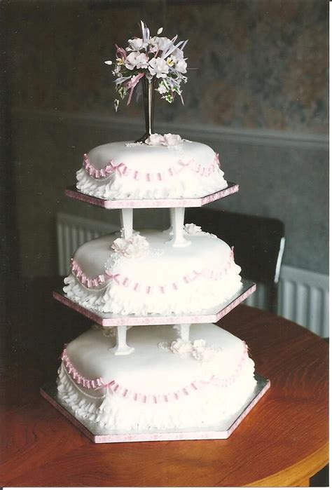 Three Tier Traditional Wedding Cake With Pillars And Pierced Ribbon