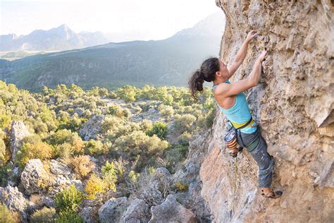 Woman Climbing A Steep Rock Wall Outdoor Poribexmedia Rock Climbing