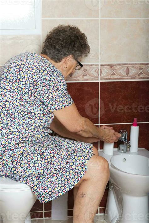 Old Woman In The Bathroom Stock Photo At Vecteezy
