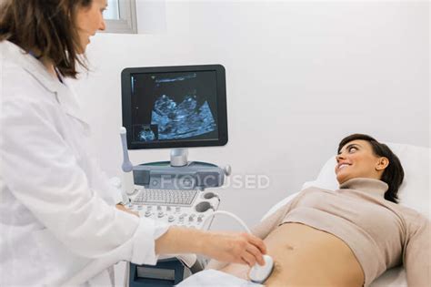 Crop Medical Practitioner Making Sonogram To Happy Pregnant Woman