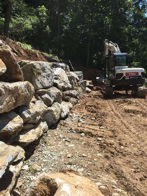 Large Boulder Retaining Wall In Progress Landscape Design