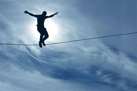 Man Balancing On A Tightrope