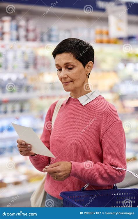 Mujer Leyendo La Lista De Compras En El Supermercado Y Usando Rosa Imagen De Archivo Imagen De