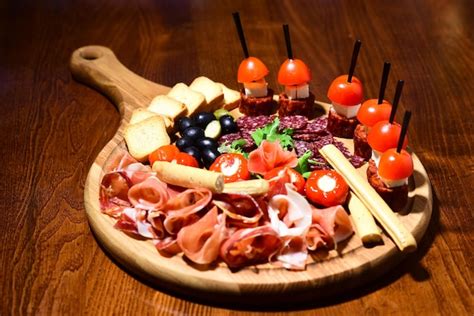 Premium Photo Meat Platter With Canape On Wooden Table Cold Meat