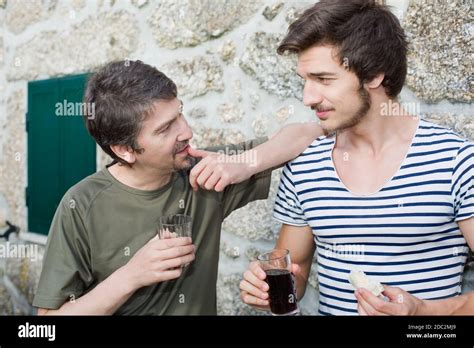 Two Friends Having A Drink And Talking Outdoors Stock Photo Alamy