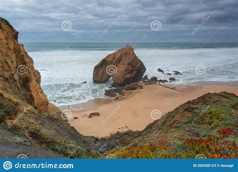 Seascape With Beautiful Yellow Sand Beach And Majestic Rock With A