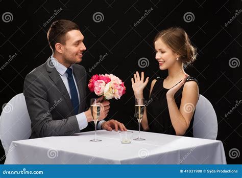 Smiling Man Giving Flower Bouquet To Woman Stock Photo Image Of Love
