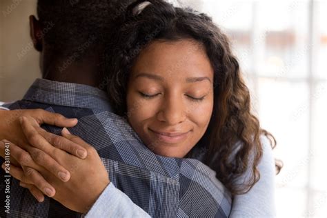 Happy African American Wife Hugging Husband Holding Tight Feeling