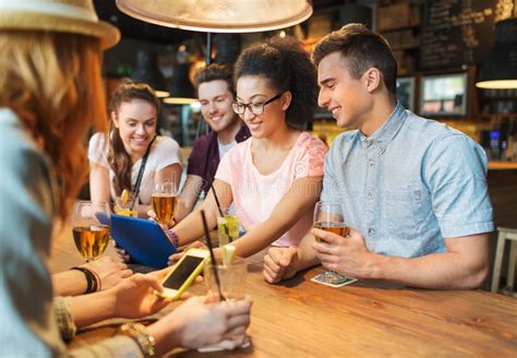 Happy Friends With Tablet Pc And Drinks At Bar Stock Image Image Of