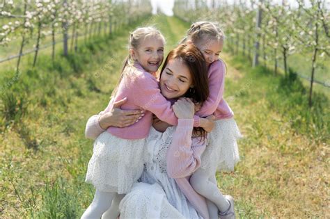 Premium Photo Portrait Of A Mother And Her Twin Daughters In A