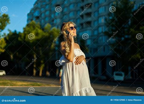 happy pregnant woman calling on smartphone at city street stock image image of caucasian