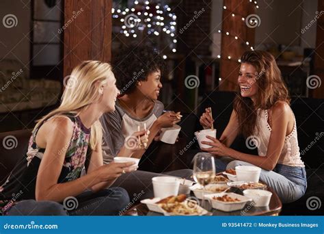 Three Female Friends Hang Out Eating A Chinese Take Away Stock Photo