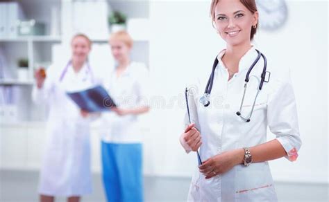 Young Woman Doctor Standing At Hospital With Medical Stethoscope Stock