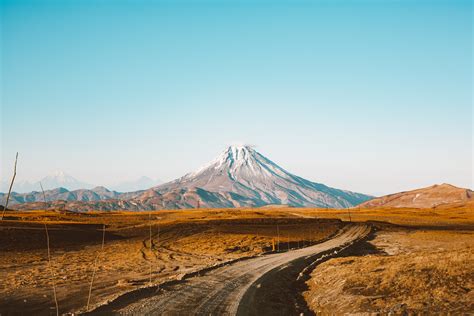 Landscape of road leading to distant mountain · Free Stock Photo