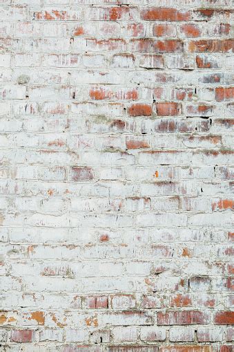 Poorly Painted Wall Of Damaged Red Brick With White Paint Stock Photo