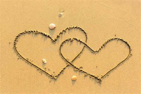 Two Hearts Drawn In The Sea Sand With The Soft Wave Love Stock Photo