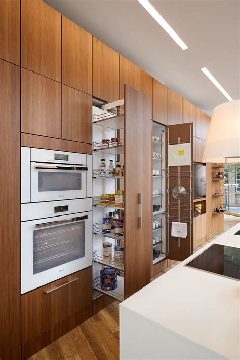 If you love the look of natural wood, walnut cabinets make a stunning presentation! Walnut Veneer Kitchen - Modern House