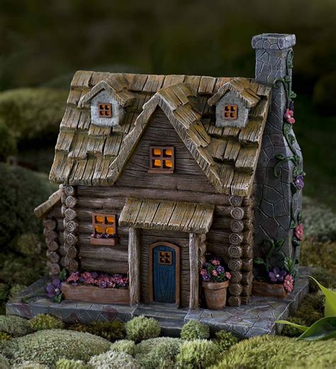 Modeled after a treehouse, this small home looks like it was built by fairy hands. Fairy Garden Solar Log Cabin | PlowHearth