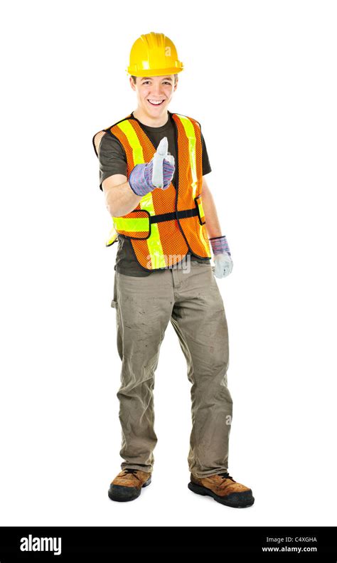 Smiling Male Construction Worker Showing Thumbs Up In Safety Vest And