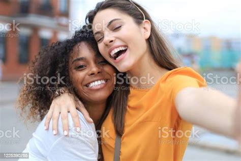 Two Laughing Friends Enjoying Weekend Together And Making Selfie On