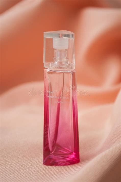 Givenchy Irresistible Perfume In Pink Bottle On Satin Background