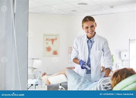 Nice Doctor Supporting Woman During Gynecological Examination Stock