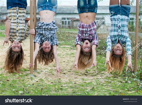 Four Young Girls Hanging Upside Down Foto De Stock Editar Ahora