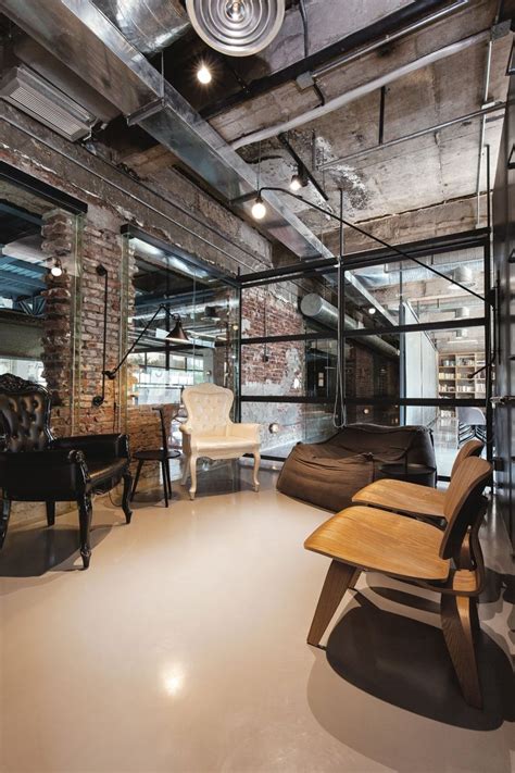 Architecturally, industrial style is mainly represented by tall ceilings, bis windows and open floor plans. Industrial Office Features Exposed Bricks & Concrete Ceilings
