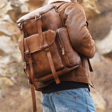 A Man With A Brown Leather Backpack On His Back