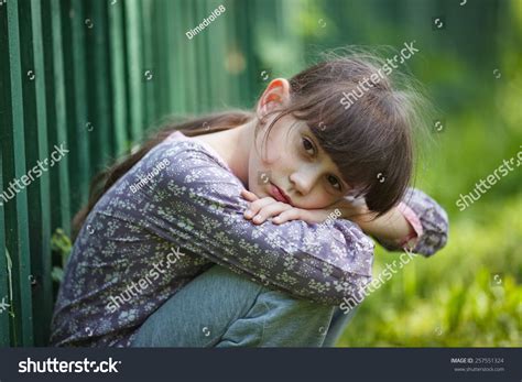 Sad Little Girl Sitting Alone On The Nature Stock Photo 257551324