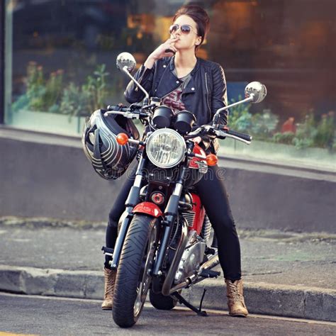 Stylish Ride A Young Female Biker Smoking A Cigarette Stock Image