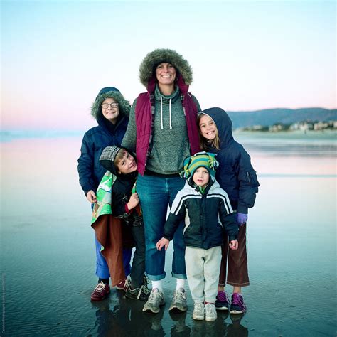 Mom And Four Kids At The Beach In Winter Del Colaborador De Stocksy